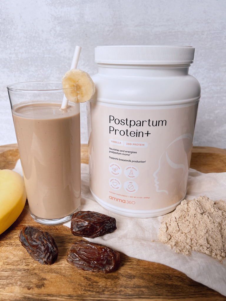 Container of amma360 Postpartum Protein+ Powder next to a banana date protein smoothie, dates, and a banana.