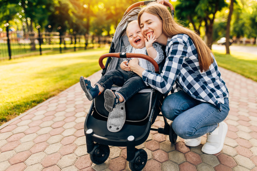 A mom and her child going on a Postnatal Stroller Walk in the park.