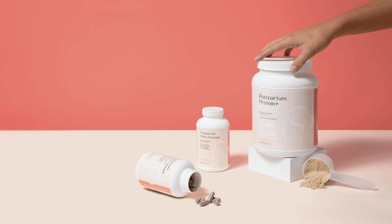 Postpartum product bundle image with hand holding product and capsules poured out on tabletop