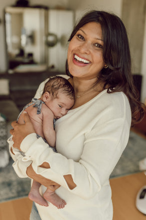 Sharmin Karmin, founder of amma360, holding her baby.
